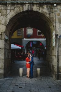 lovers posing at porty city in a arch of stone by Ribeira do Douro